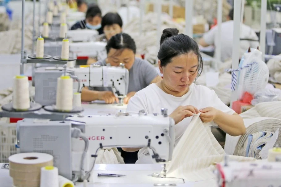 Workers at a garment factory on July 30 in Suixi County, Huaibei City, Anhui Province of China.