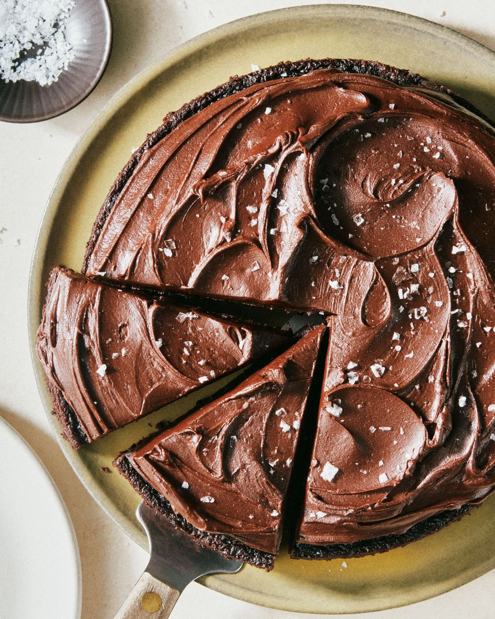 A chocolate cake make with olive oil and topped with flakey sea salt.