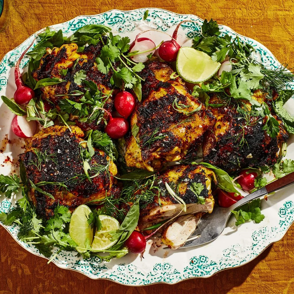 YogurtMarinated Chicken With Hot Honey and Herbs on a green and white plate