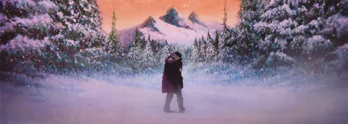 two people kissing in the snow