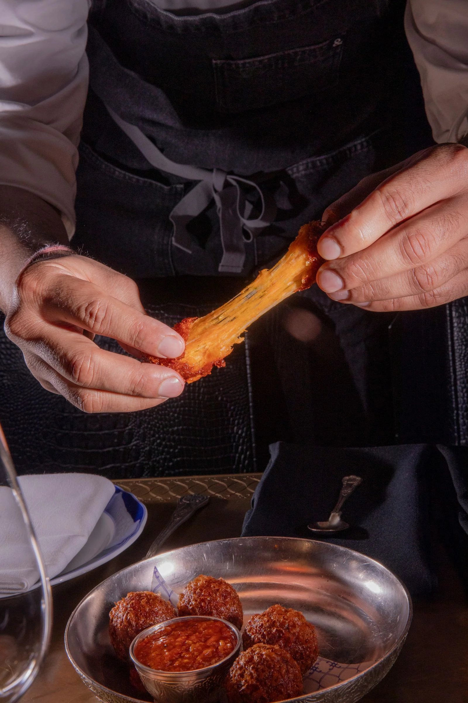Image may contain Food Food Presentation Fritters Adult Person Cutlery Spoon and Plate