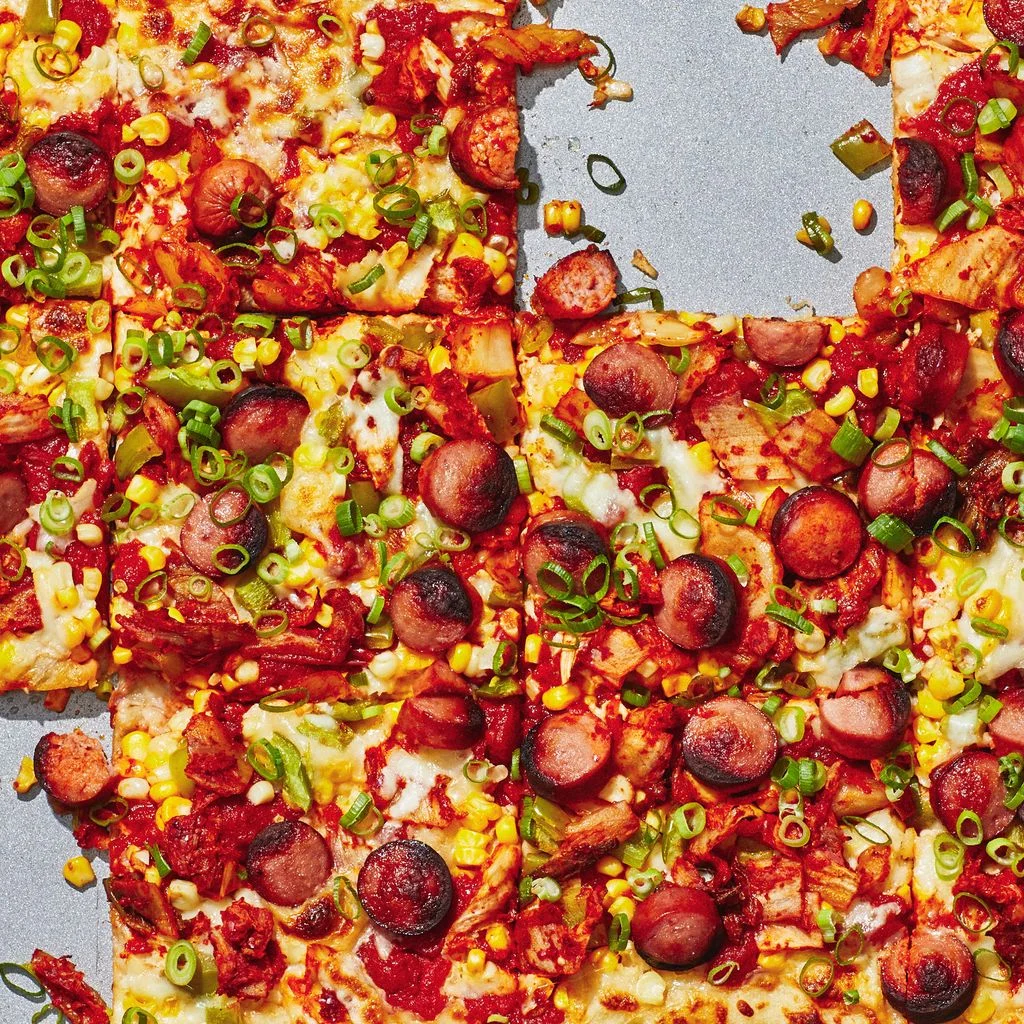 Closeup of bacon kimchi pizza.