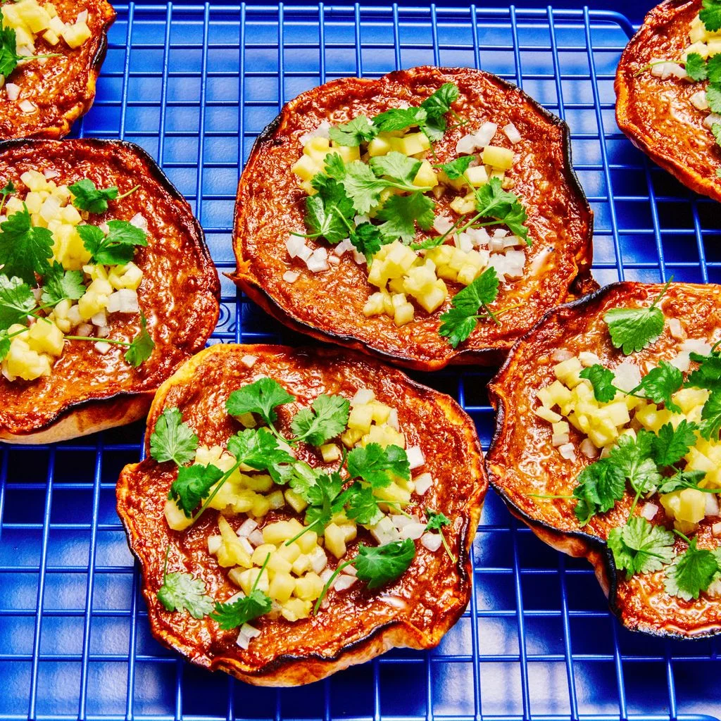 Smashed tacos on a blue tray and blue cooling rack