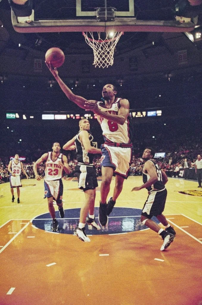 NBA player in New York Knicks number 8 jersey drives to the basket for a layup against the San Antonio Spurs at Madison Square Garden