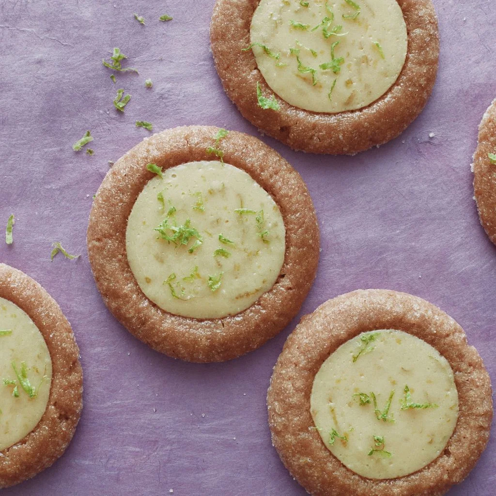 Thumbprint cookies filled with key lime pie flavored custard and topped with lime zest.
