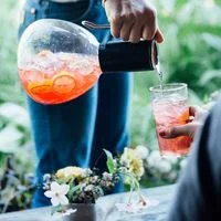 Image may contain: Human, Person, Drink, Beverage, Cocktail, Alcohol, Glass, and Finger