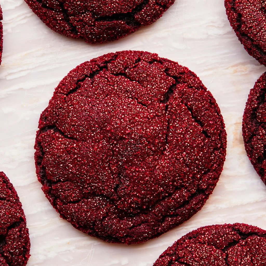 Overhead shot of red velvet cookies coated in sparkly sanding sugar.