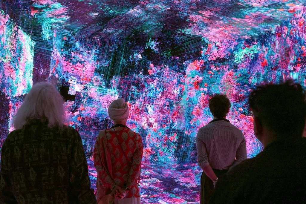 an immersive, glowing digital environment featuring abstract, vibrant pink and blue floral textures layered over geometric data grids