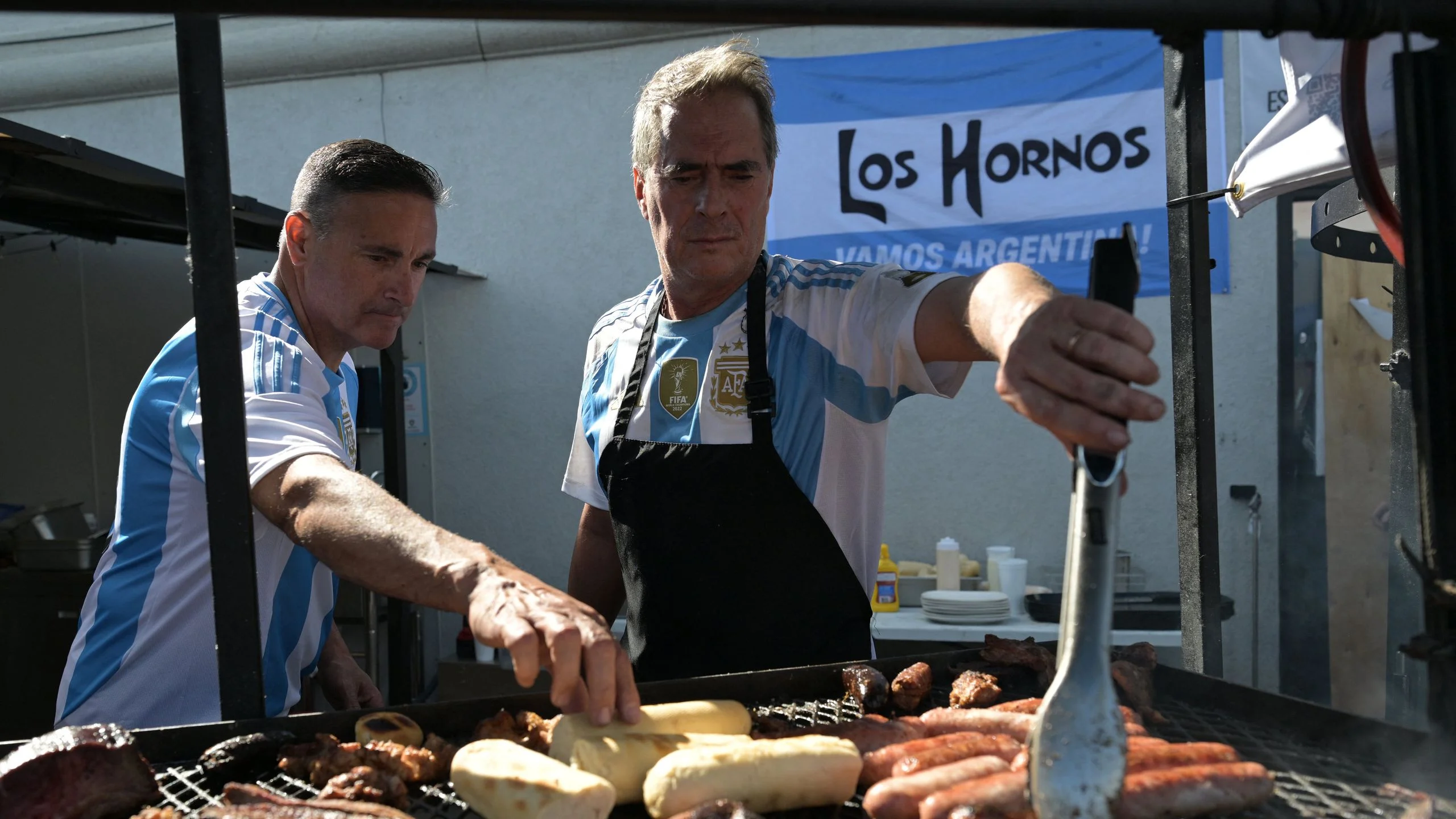 Workers prepare chorizos asados at Los Hornos restaurant that caters  barbecue specialties near Kansas City Missouri...