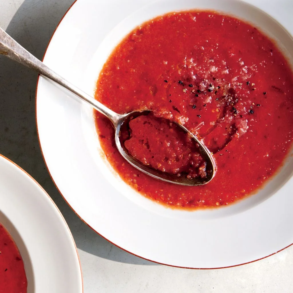 Two bowls of vibrant red stone fruit gazpacho.