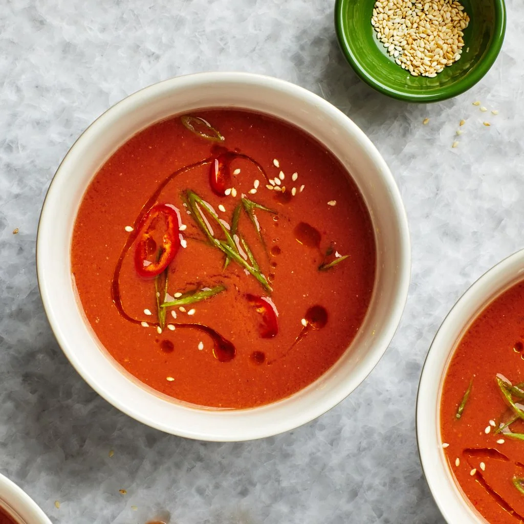 Gazpacho in a white bowl on metallic patterned table