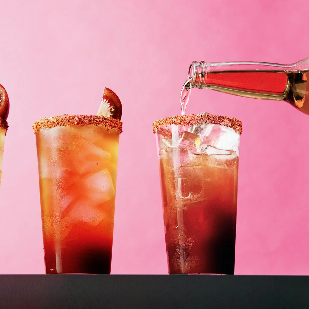 3 glasses against a pink background.