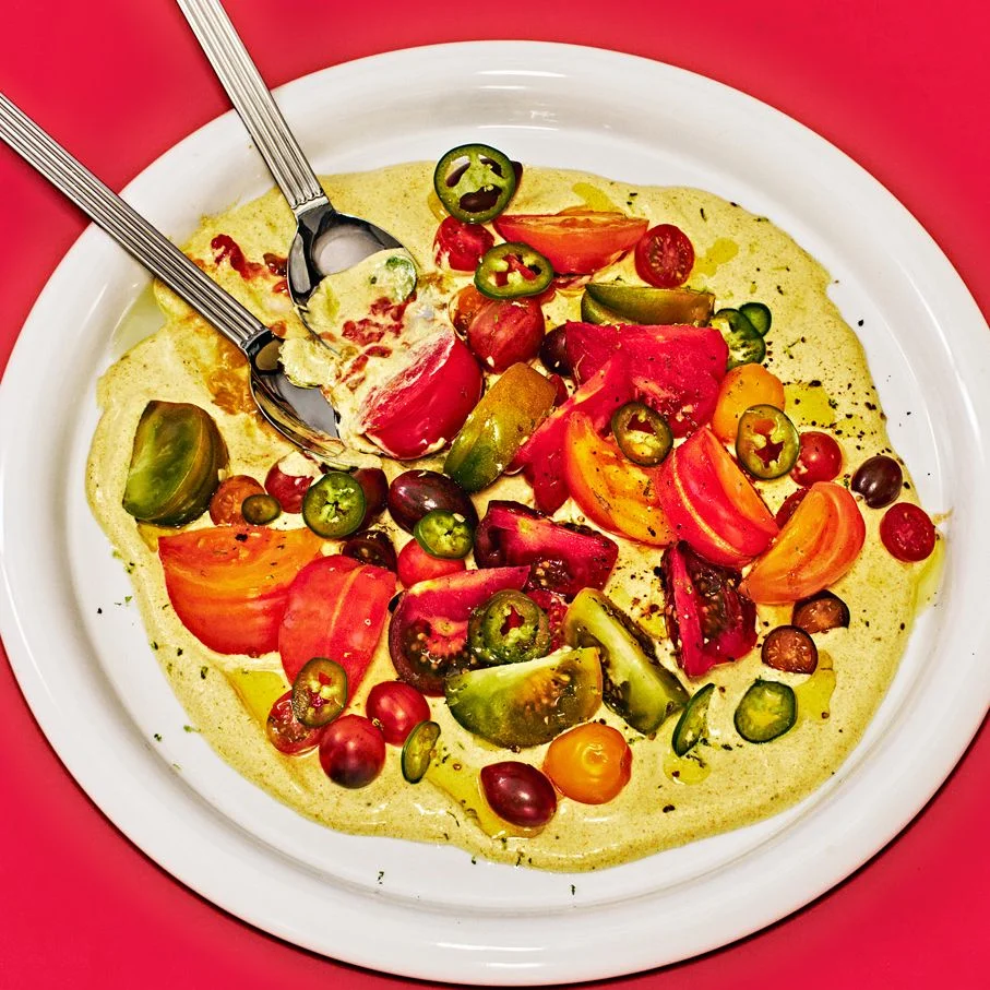 Tomatoes With Curry Yogurt on a white plate placed on a red background