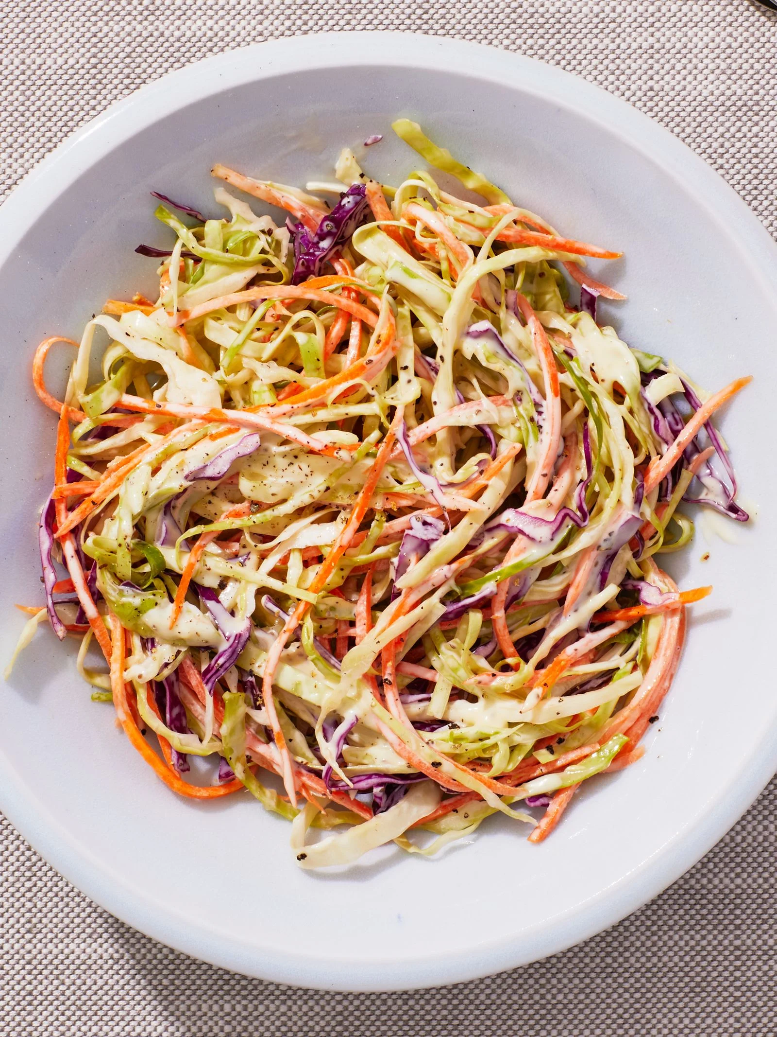 Cole Slaw in a white bowl on a fabric