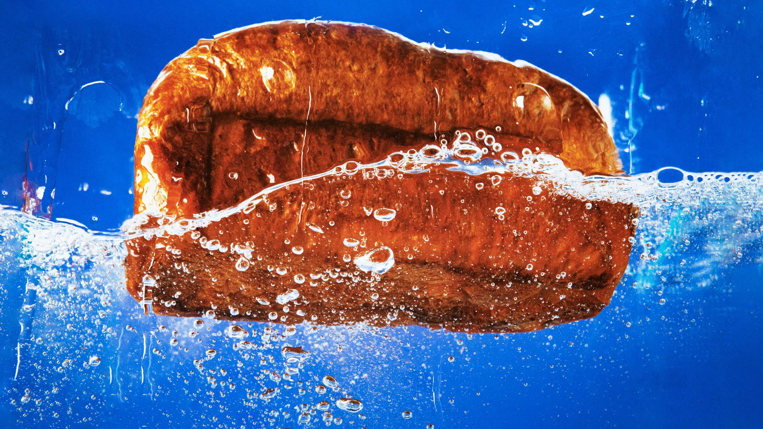 A loaf of bread in water demonstrating how to revive stale bread.
