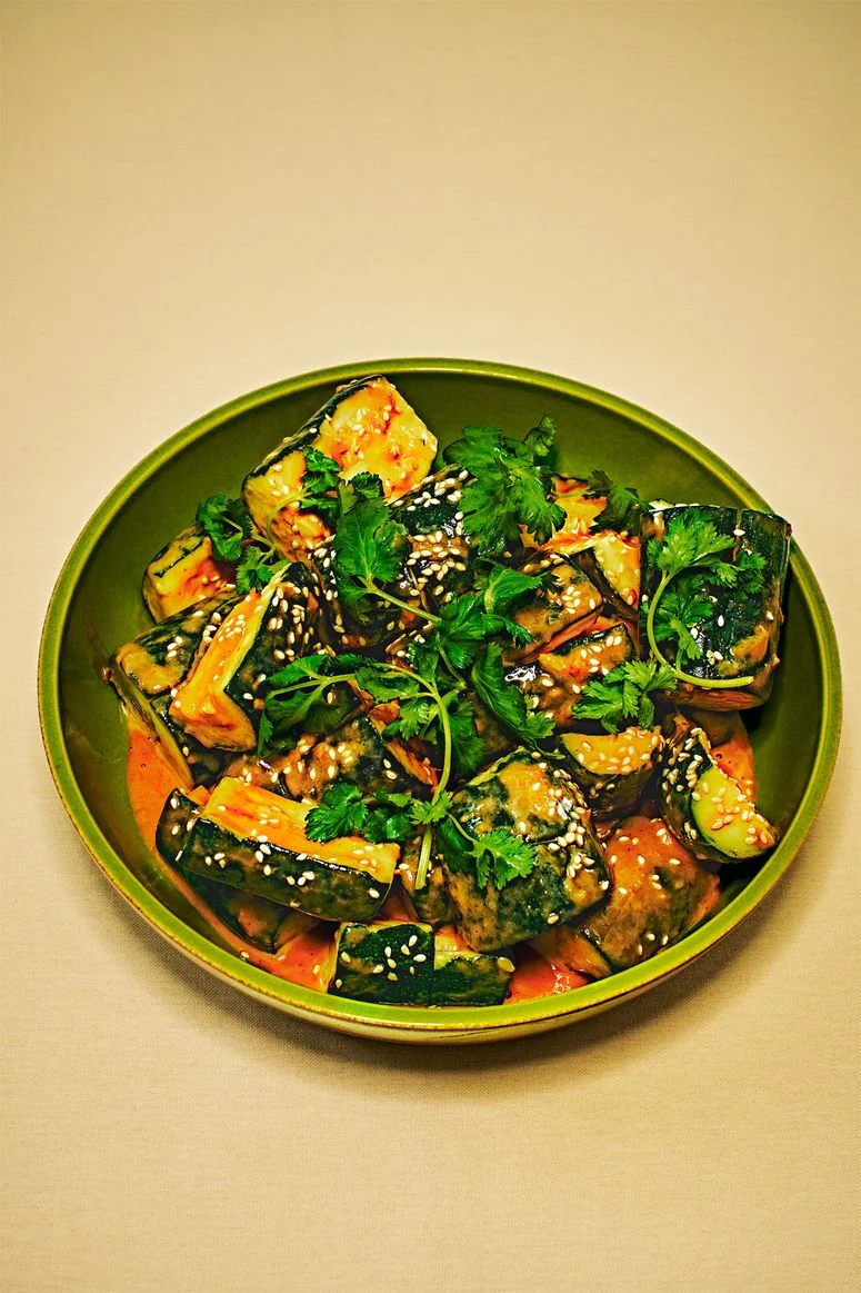 Smashed Zucchini With TahiniGinger Dressing in a green plate