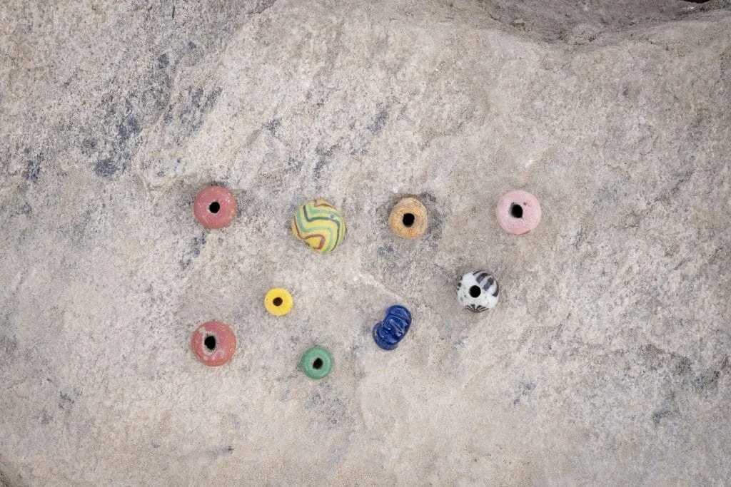 an aerial view view of beads that are brightly colored on a rock